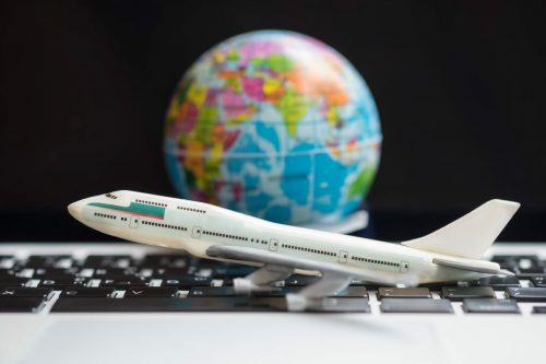 Travel,Concept.,Airplane,Model,Toy,On,Laptop,Computer,With,Mini Globus Flugzeug 621470483 scaled 500x0 c default