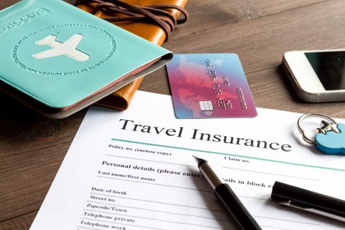 Concept,Booking,Travel,Insurance,On,Wooden,Background Reiseversicherung shutterstock 556915345 scaled 500x0 c default