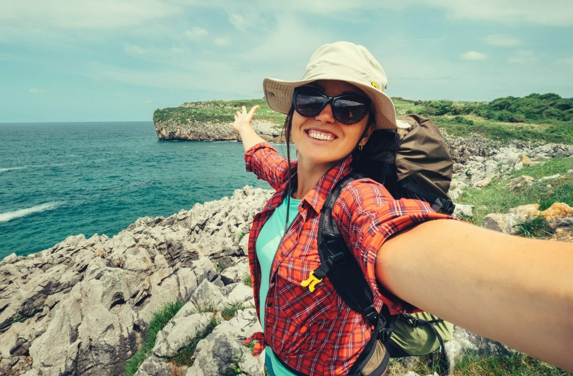 Happy,Woman,Backpacker,Traveler,Take,A,Selfie,Photo,On,Amazing shutterstock 1086681950 scaled