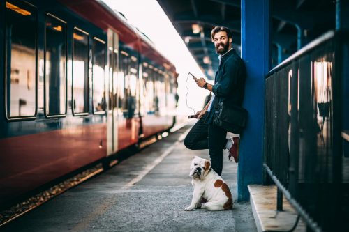 Young,Man,Using,Mobile,Phone,At,Train,Station shutterstock 768346339 scaled 500x0 c default