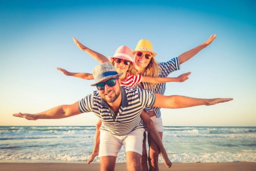 Happy,Family,On,The,Beach.,People,Having,Fun,On,Summer