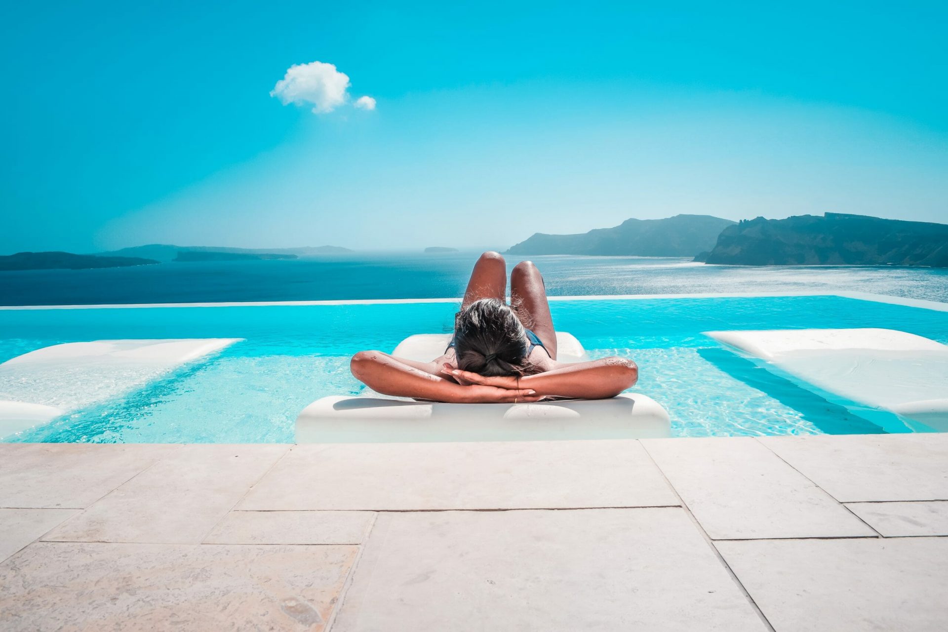 Young,Woman,On,Vacation,At,Santorini,,Women,At,The,Swimming