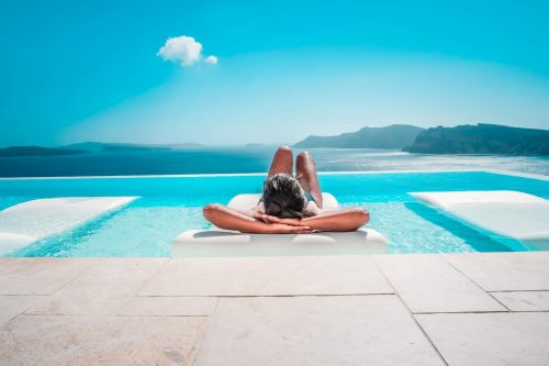 Young,Woman,On,Vacation,At,Santorini,,Women,At,The,Swimming