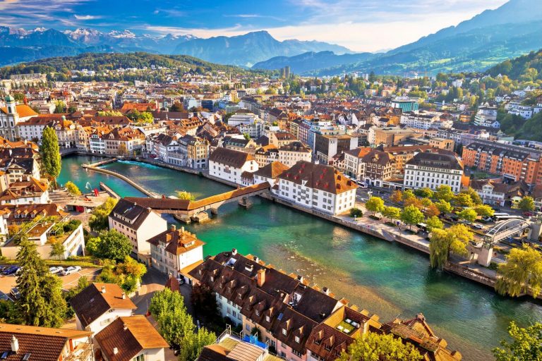 City,Of,Luzern,Riverfront,And,Rooftops,Aerial,View,,Alps,Landscape