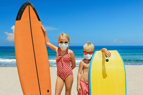 Young,Surfer,Kids,With,Surf,Boards,Wear,Protective,Mask,On