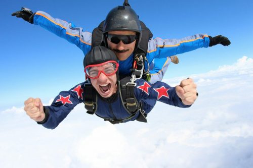 Skydiving.,Tandem,Passenger,Is,Very,Happy.
